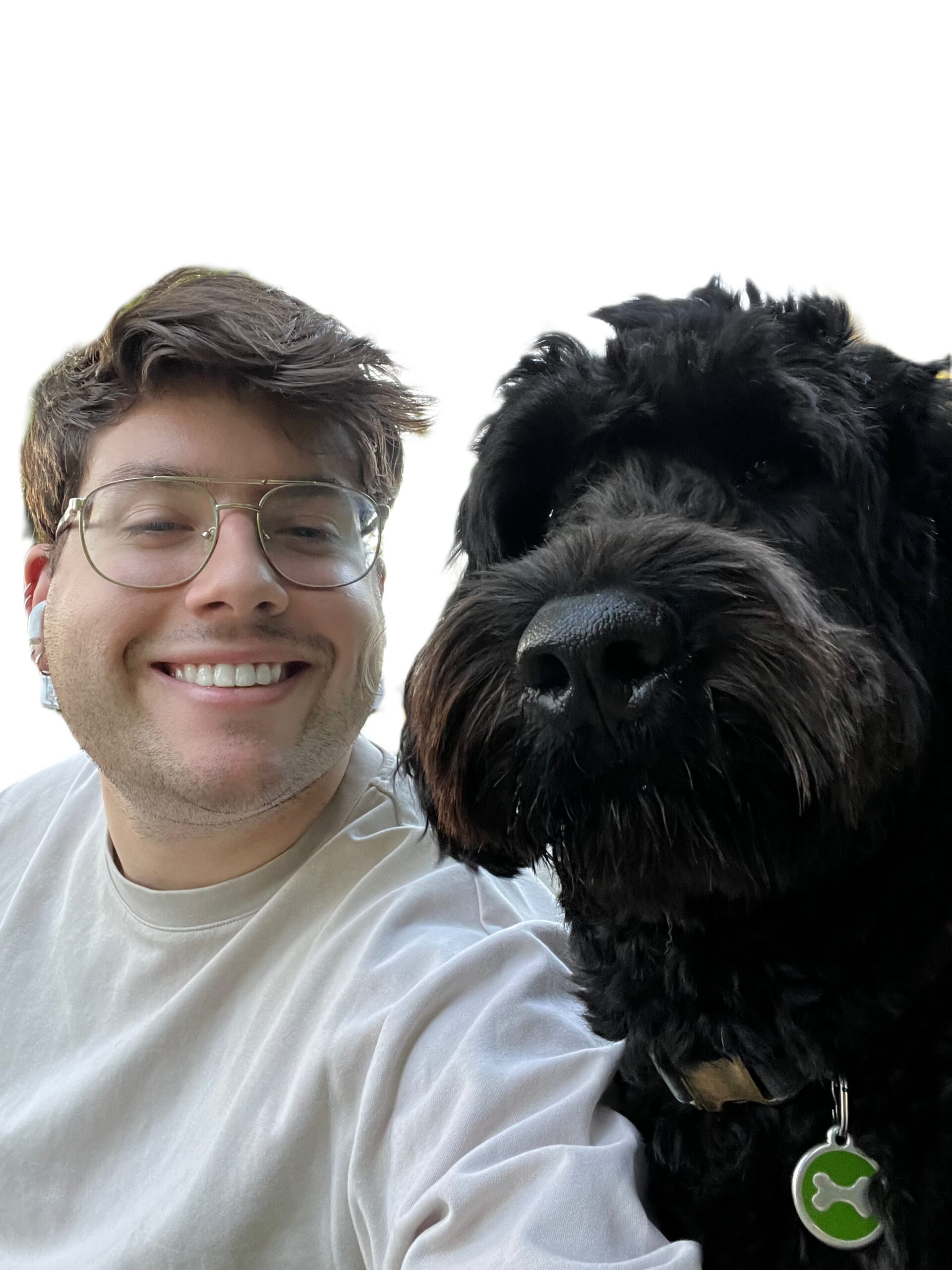Image of Vincent with his black Portuguese water dog